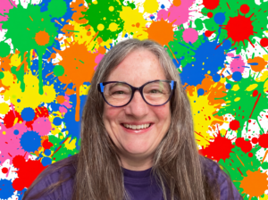 beautiful white woman age 60ish with glasses and a big smile